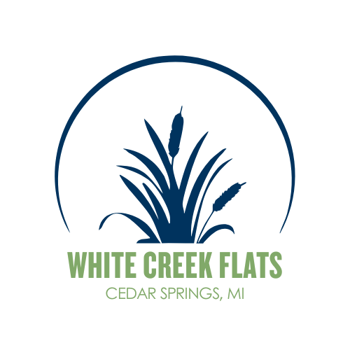White creek flats logo with a plant in the middle.